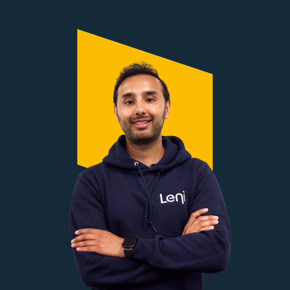 Zain, Leni team member, in a hoodie against a yellow background.
